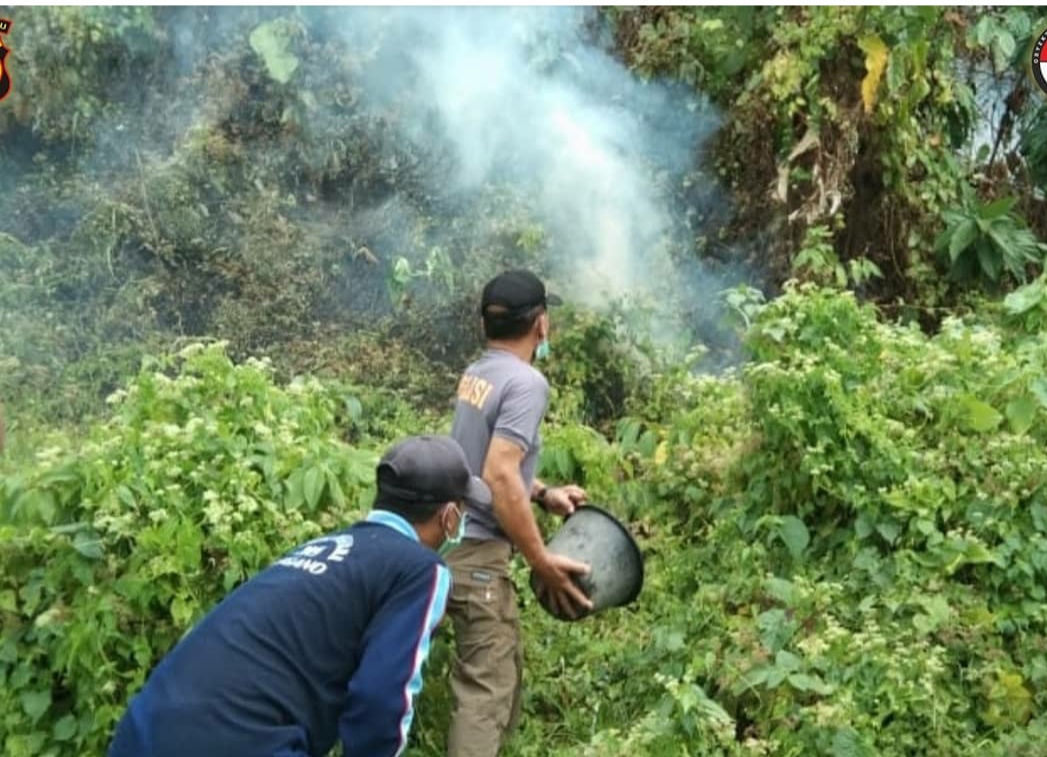 Kapolsek Enggano Bersama Personel Polsek dan Masyarakat Berupaya Memadamkan Kebakaran Lahan Di Pulau Enggano